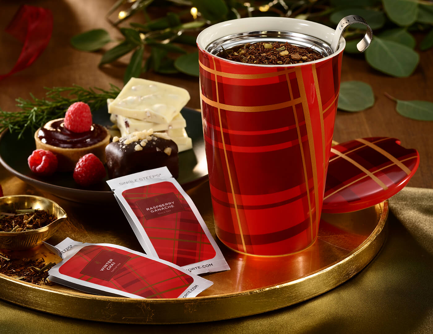 Warming Joy Kati Cup, open on a tray with tea inside and tea pouches surrounding it
