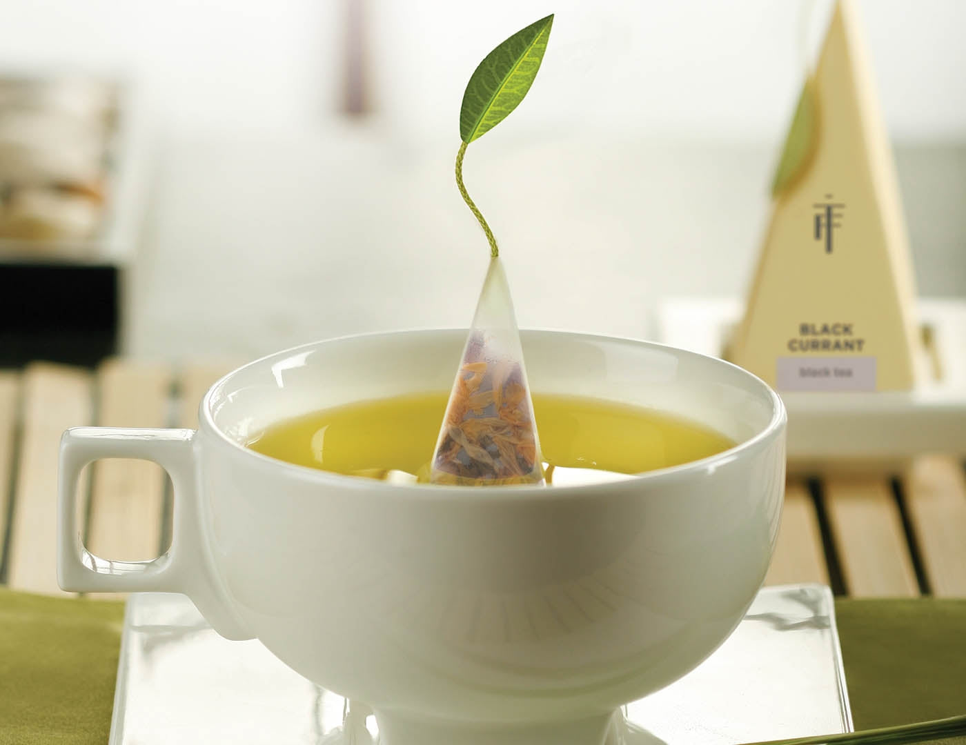 Solstice teacup with pyramid tea infuser inside