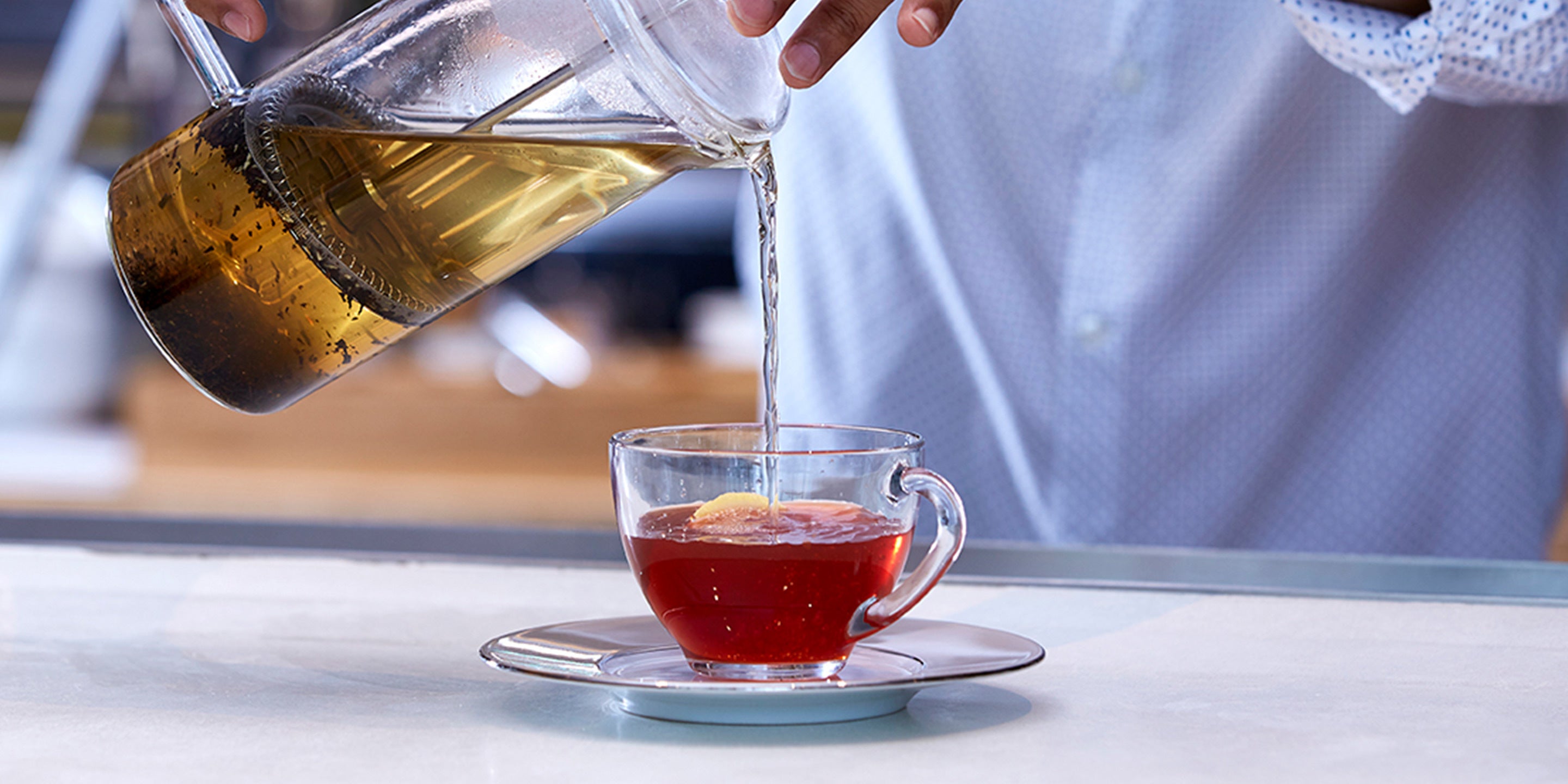 Pouring a Bombay Chai Toddy into a glass cup