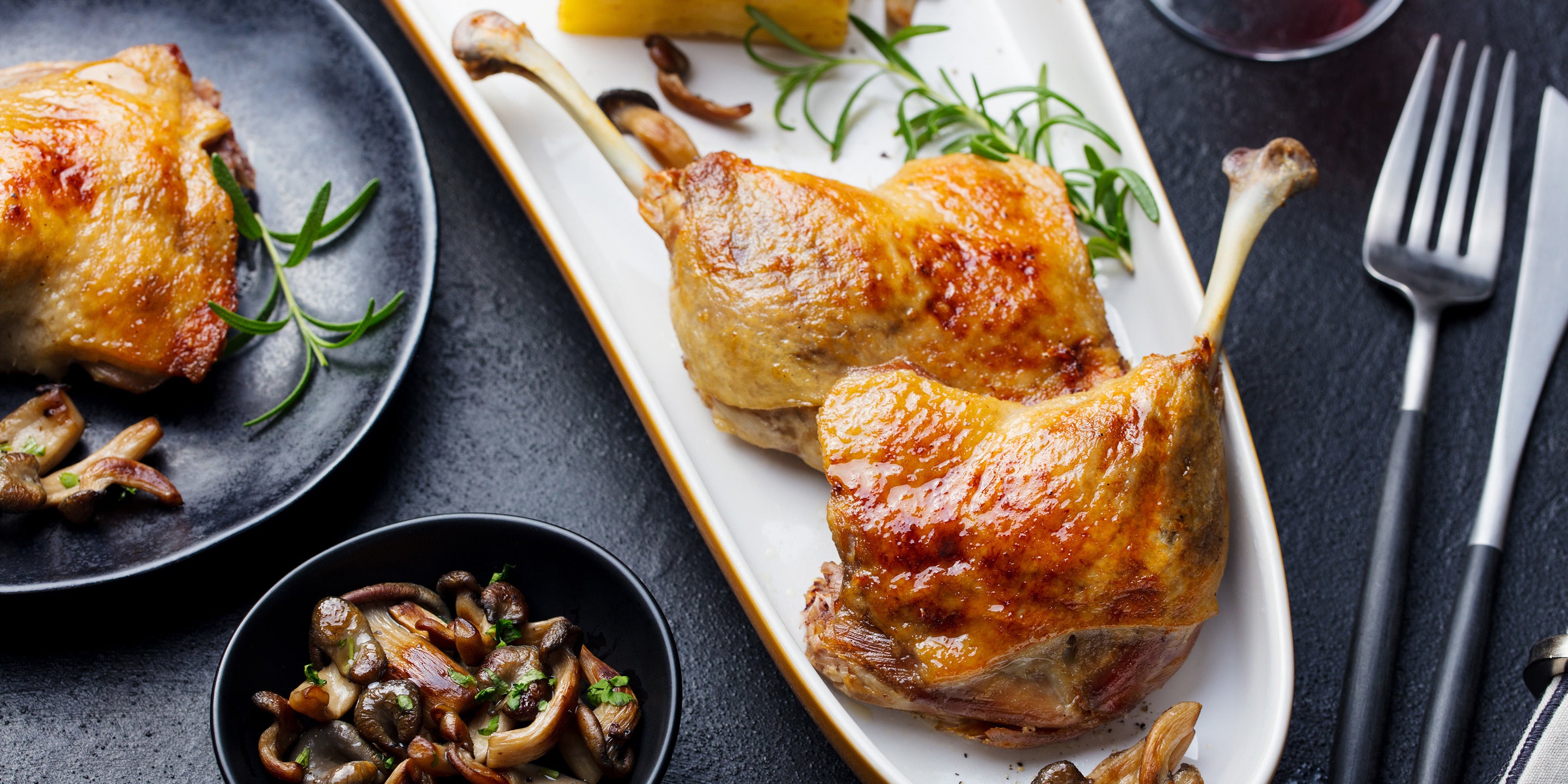 A dinner of cooked chicken legs on a plate for serving