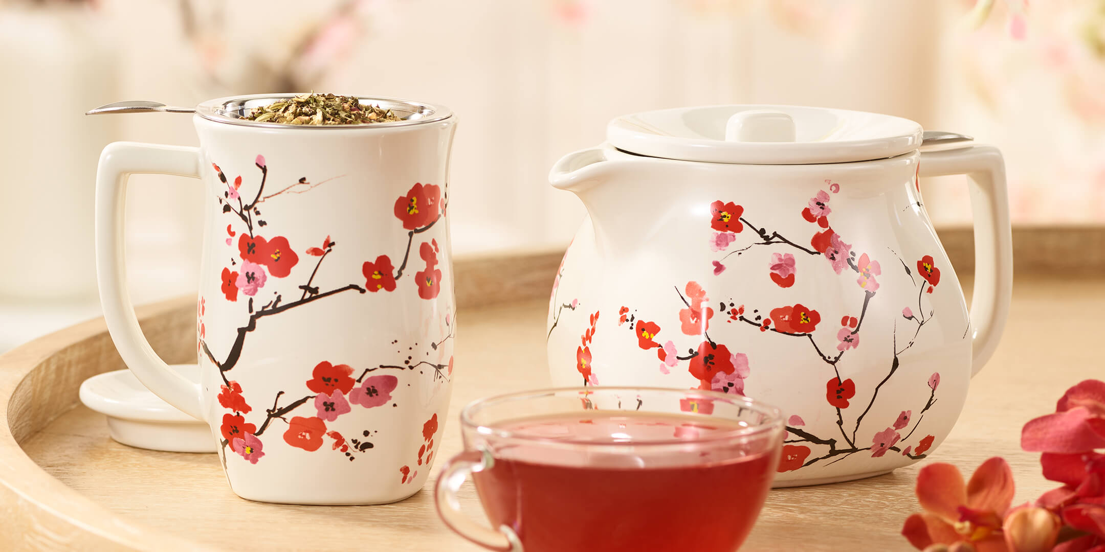 Fiore Sakura Teapot and Steeping Cup with a glass cup of tea 