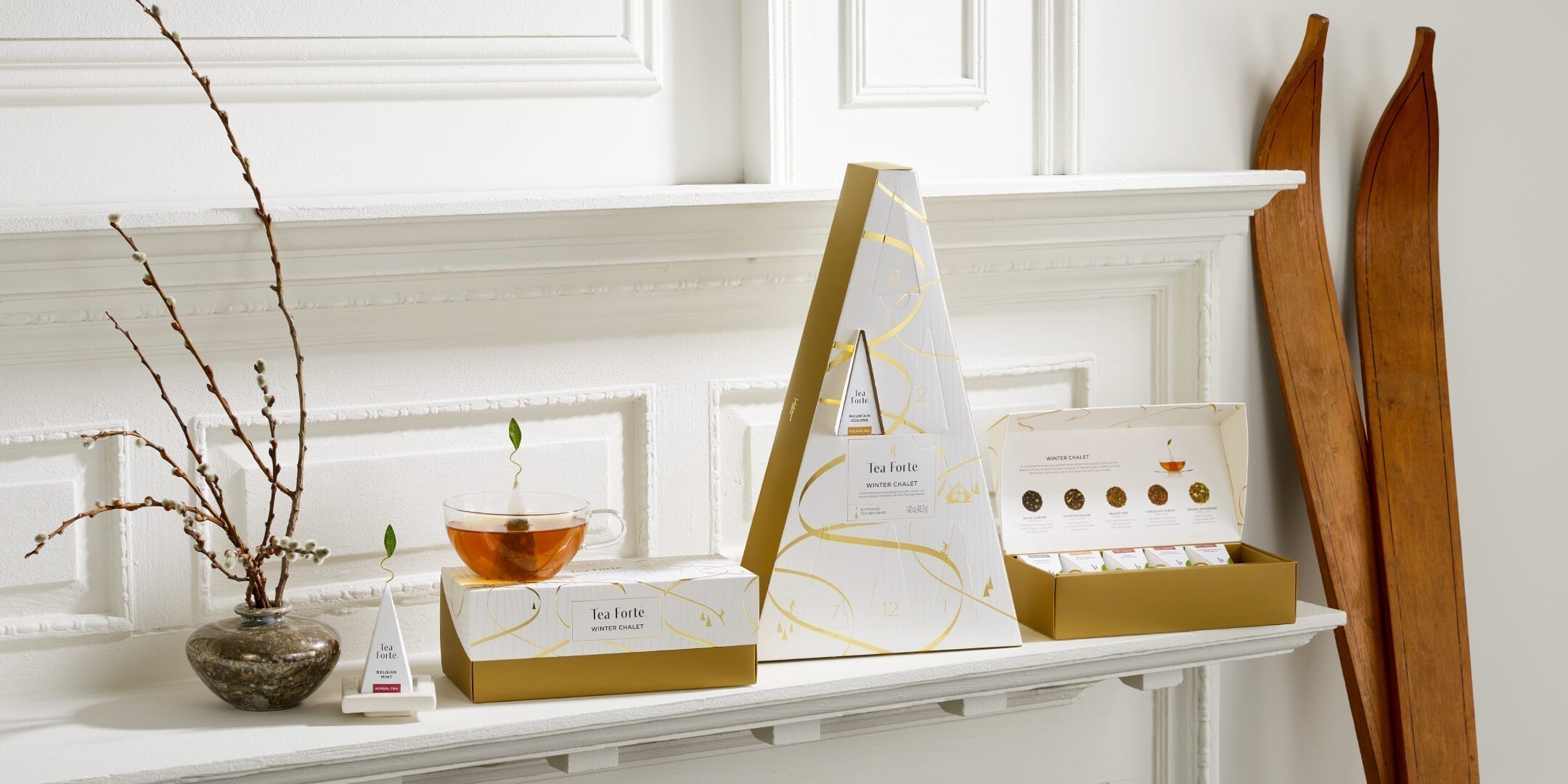 Winter Chalet Collection ona white shelf with antique wooden skis