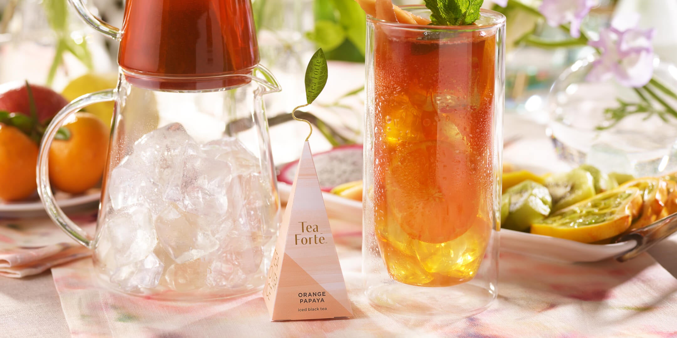 Glass of Orange Papaya iced tea with infuser