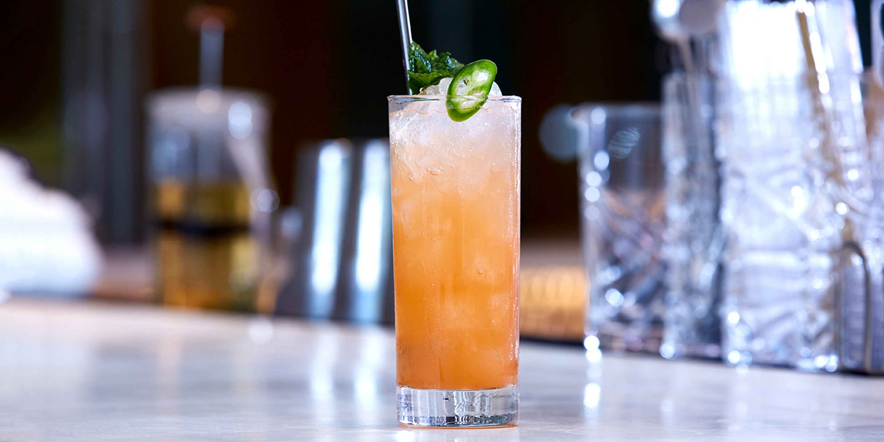 Orchid Vanilla Collins in a glass on a bar