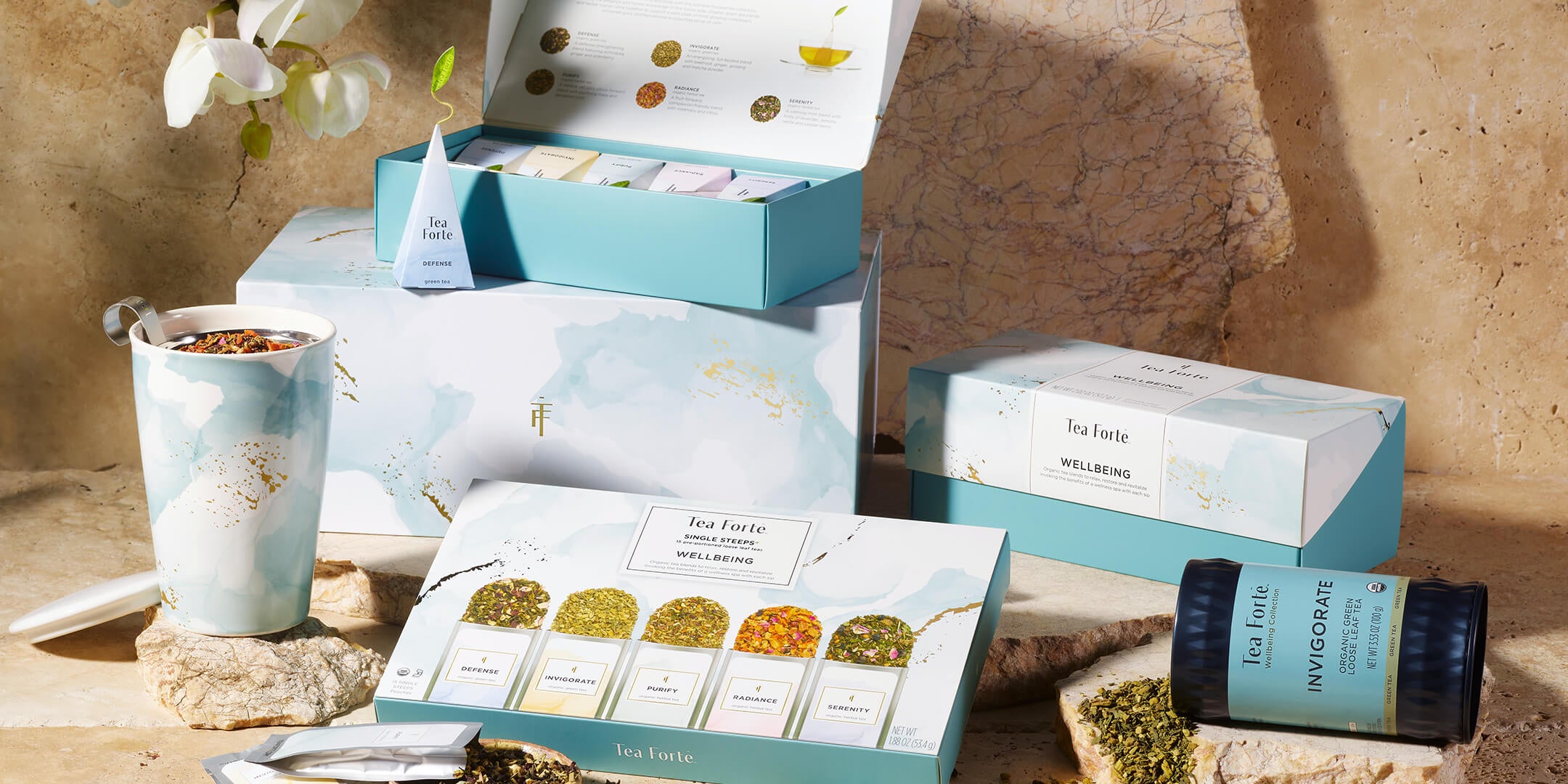 Wellbeing Petite and Presentation boxes with tea and infuser in the foreground