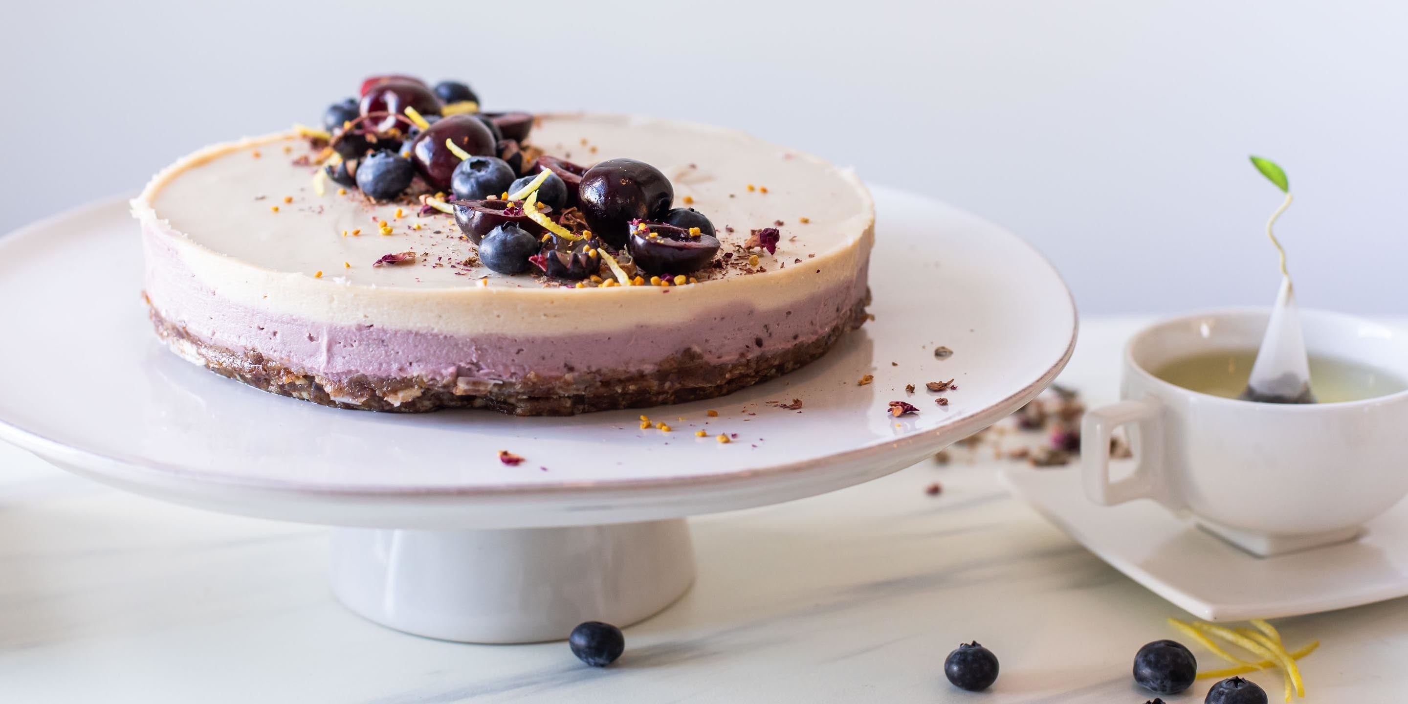 Cherry Blossom Cashew Cheesecake on a cake pedestal