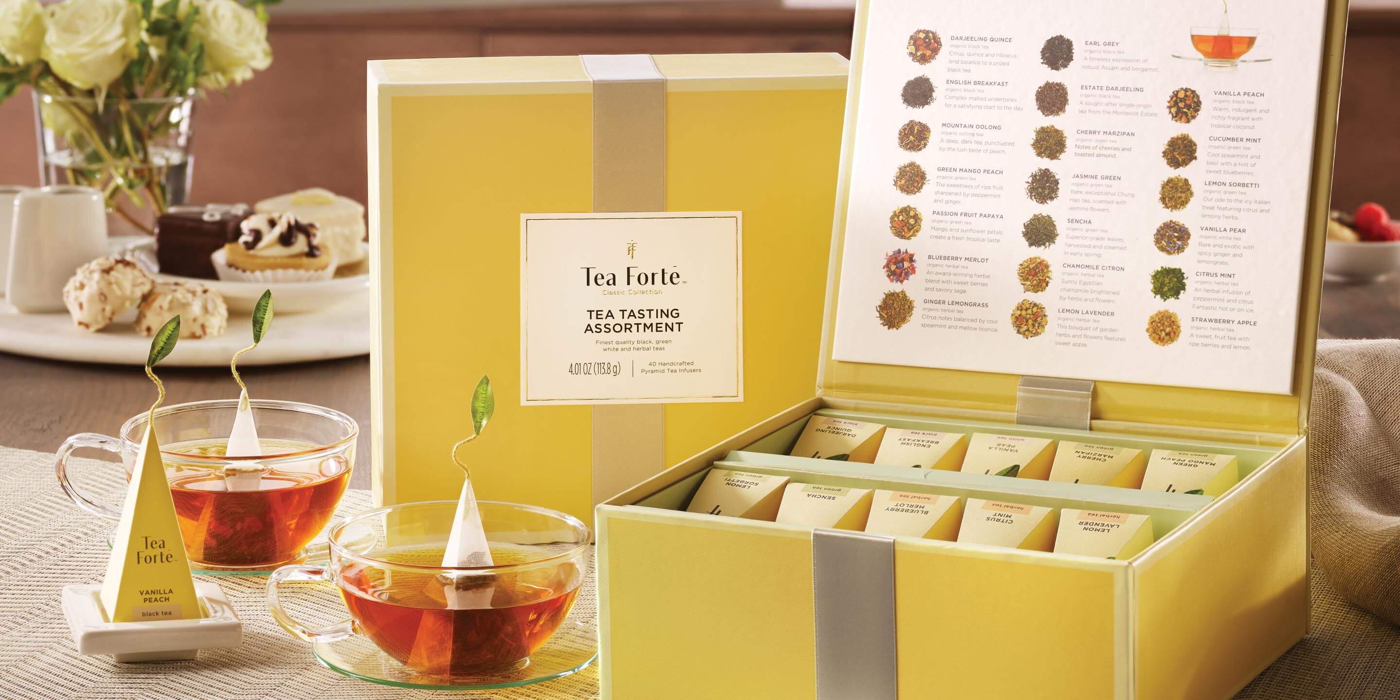 Tea Chest with open lid in front, closed lid in back, with glass cups of tea