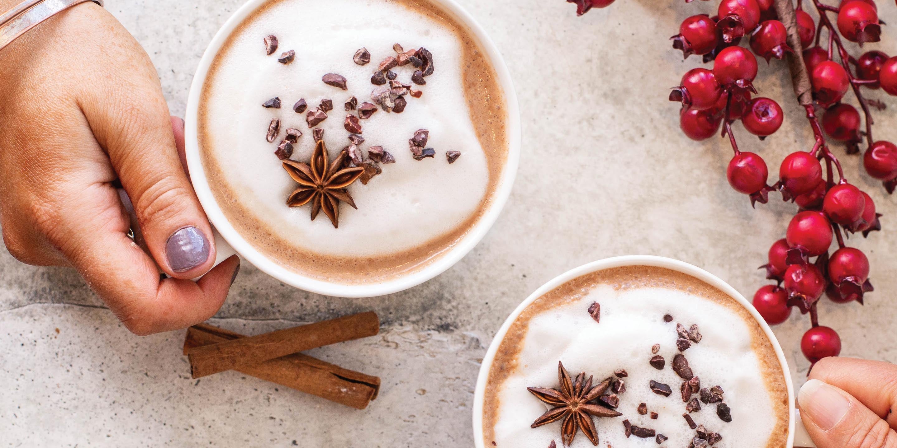 Holding cups of Winter Chai Hot Chocolate