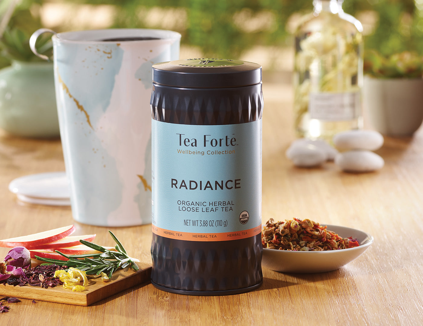 Radiance Loose Tea Canister of 35-50 servings on a table with a Wellbeing KATI Cup in the background