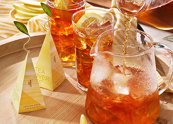 Iced Tea being pouring into a glass pitcher