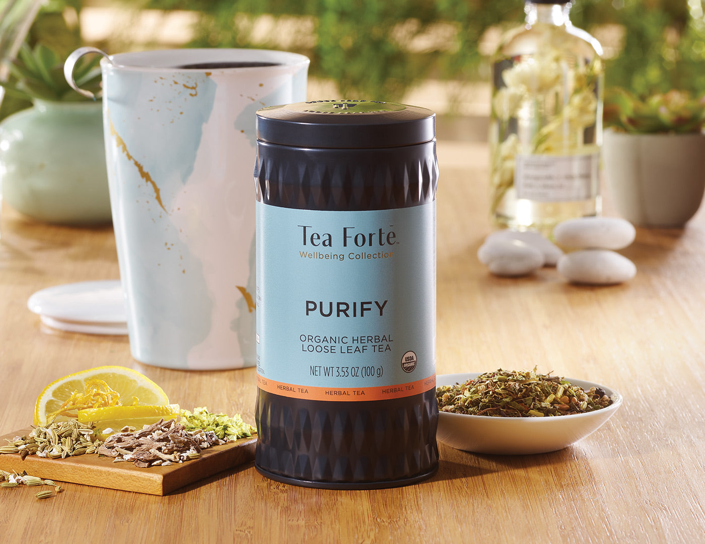 Purify Loose Tea Canister of 35-50 servings on a table with a Wellbeing KATI Cup in the background