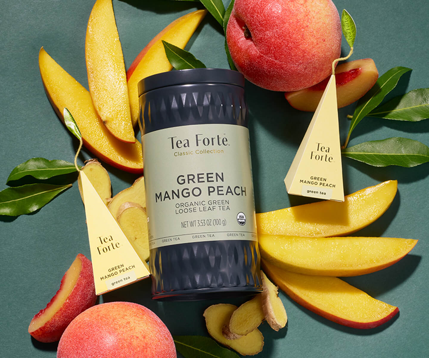 Green Mango Peach Loose Leaf tea canister surrounded by peaches, peach slices and leaves