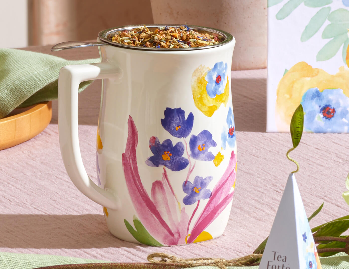 Volaré Fiore Steeping cup with an infuser basket inside filled with loose tea leaves 