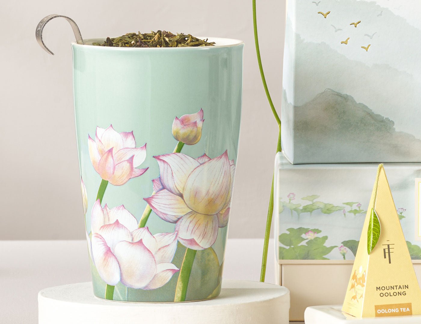 KATI® Steeping Cup & Infuser with Lotus flower pattern, open with loose tea and infuser to side