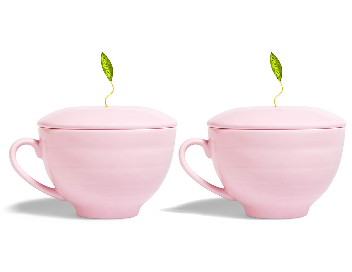 Two Pink Café Cups with lids and tea infuser leaves peeking out of the top of each.
