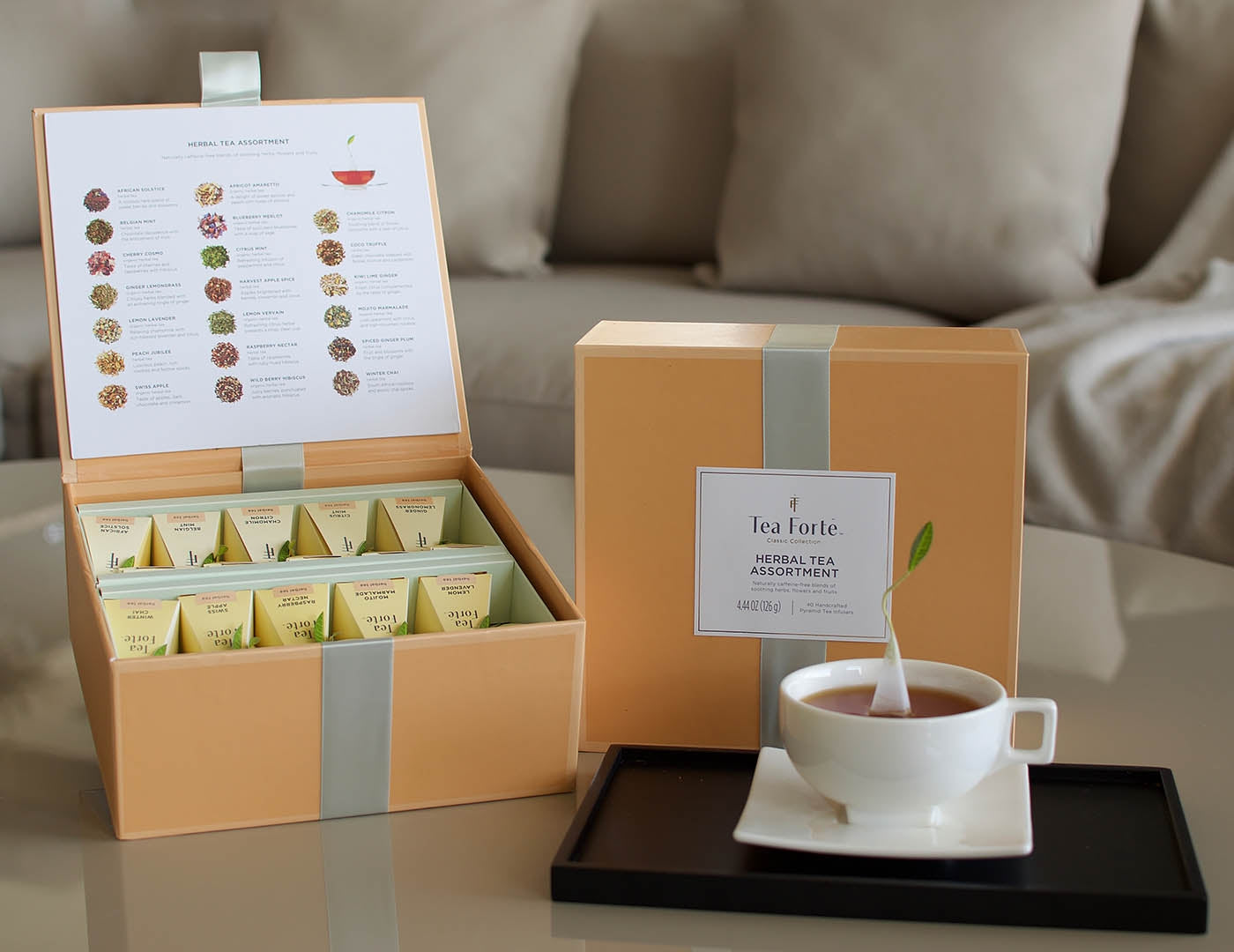 Herbal Tea Chest open with closed box and cup of tea in living room