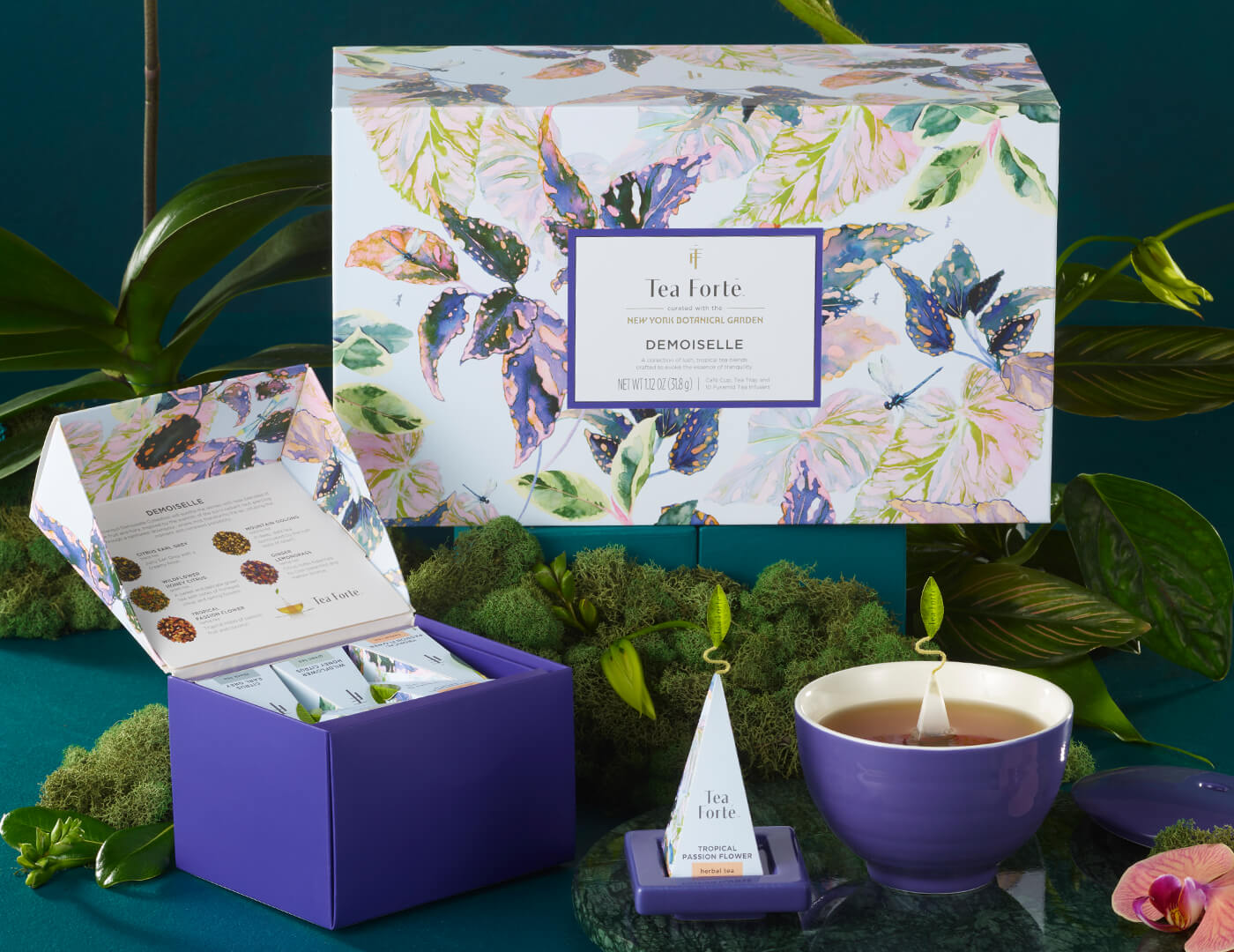 Demoiselle Gift Set with all items shown in front of the gift box, amongst moss and flowers