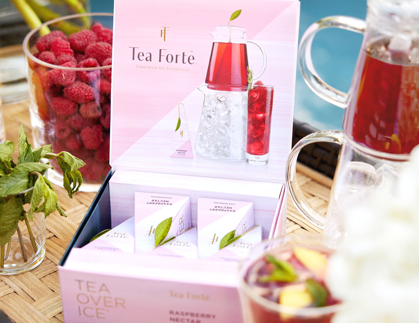 Tea Over Ice Raspberry Nectar 5pk open with iced tea and berries