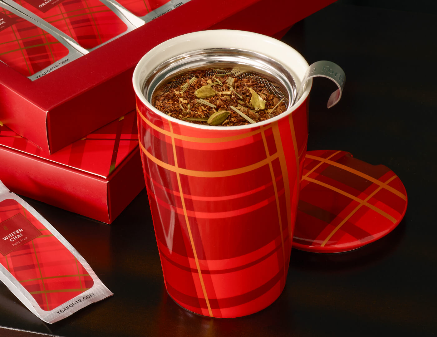 Warming Joy KATI Steeping Cup with infuser basket and lid, open and steeping tea on a table