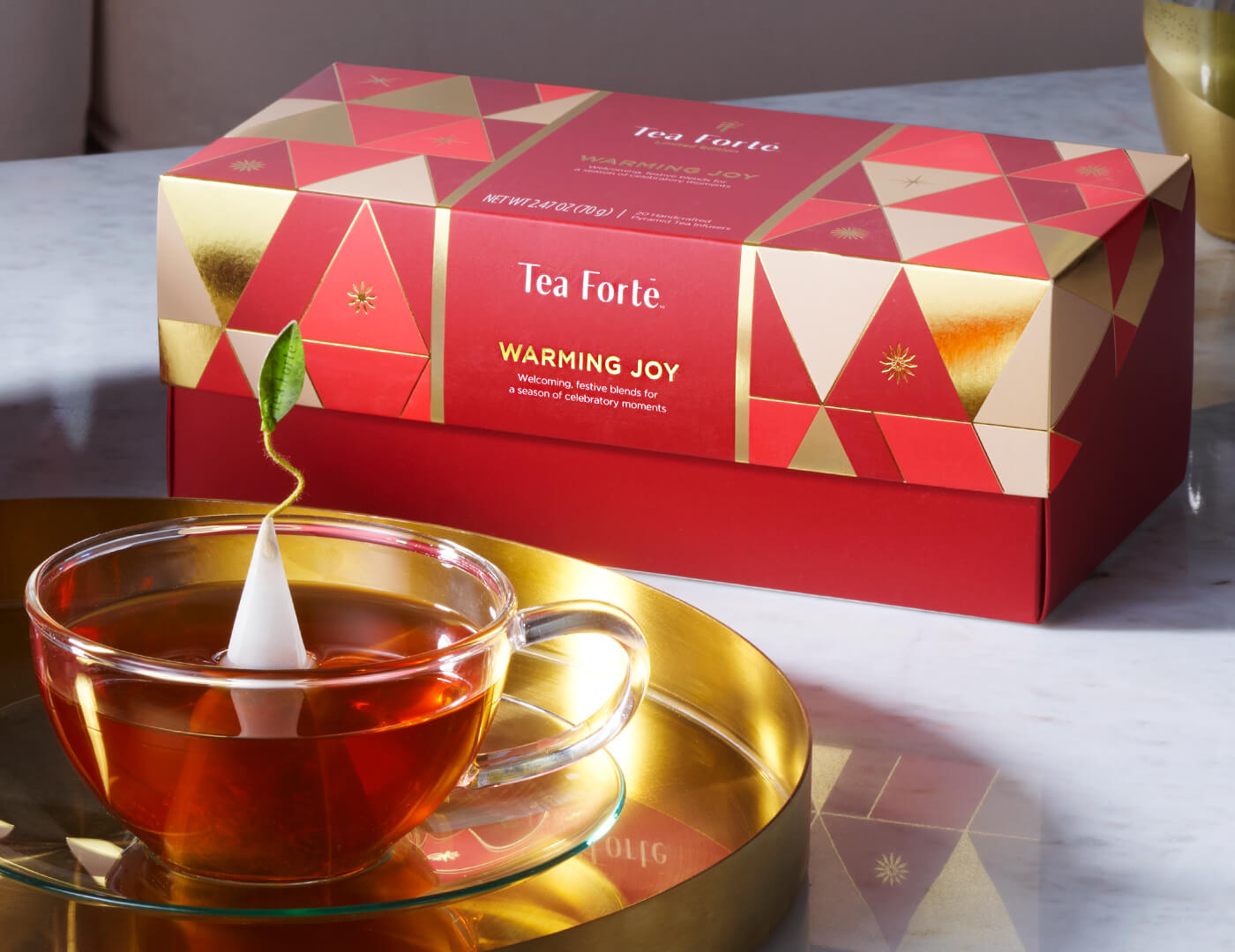 Warming Joy Presentation Box, closed with a glass cup of tea