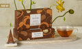 NEW! Spiced Chai Petite Presentation Boxes with yellow flowers and a glass of tea and infuser