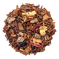 Loose tea blend with dried apple pieces, cinnamon sticks, and red flower petals on white background.