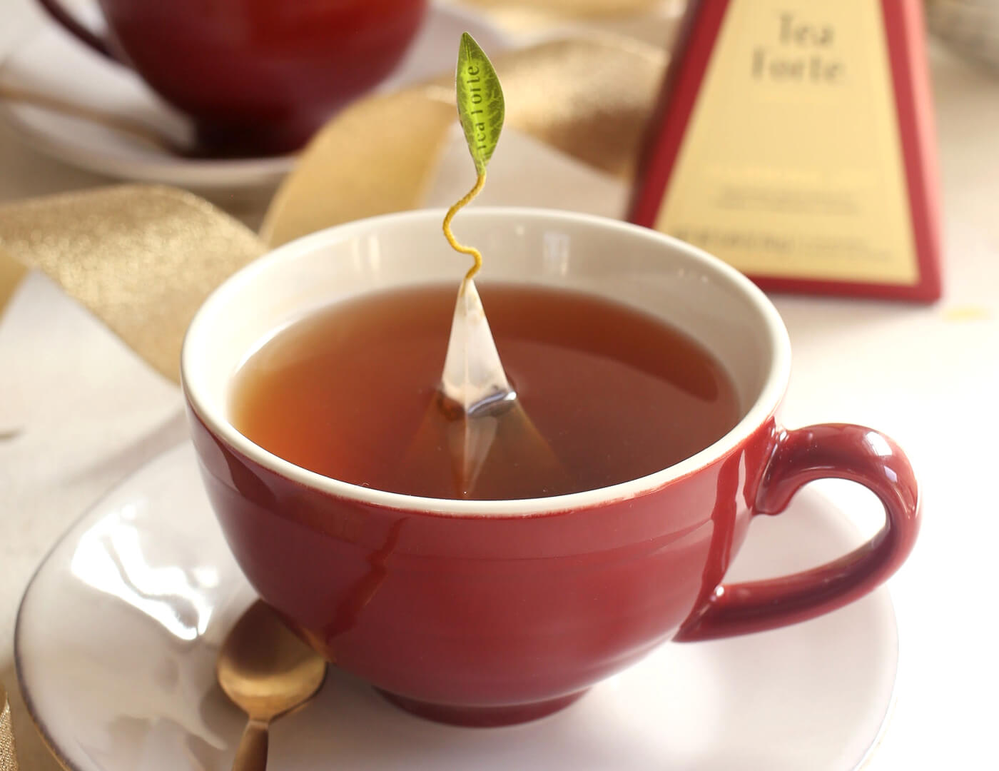 Red Café Cup with lid off, tea infuser steeping inside.