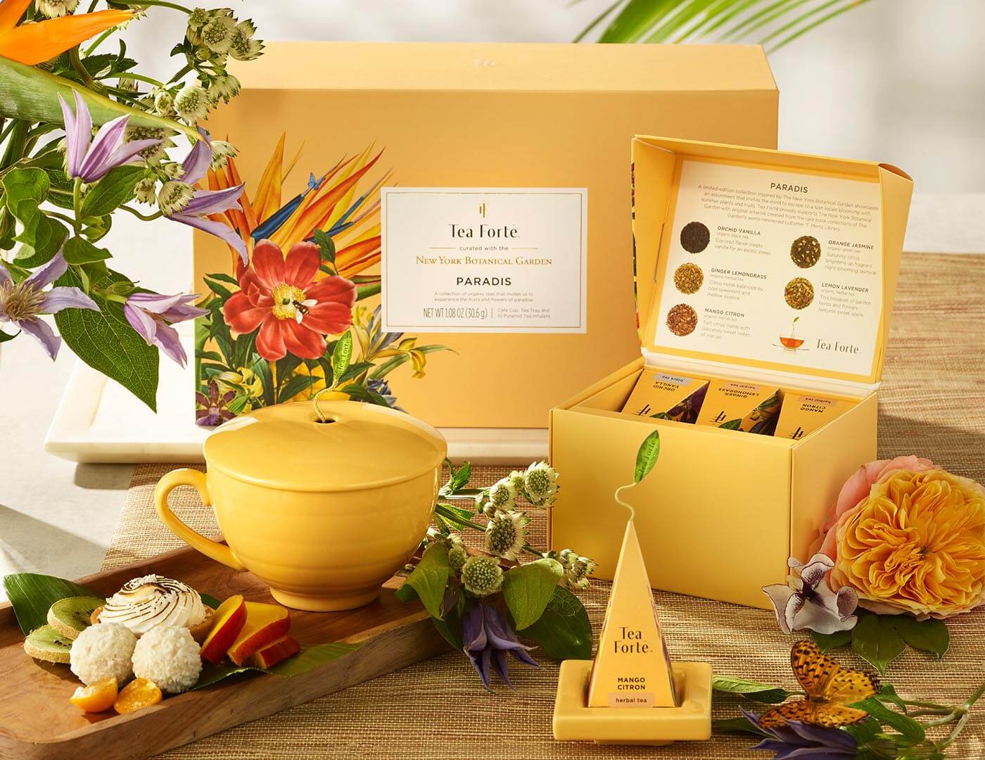 Paradis Gift Set with items shown in front of box and flowers
