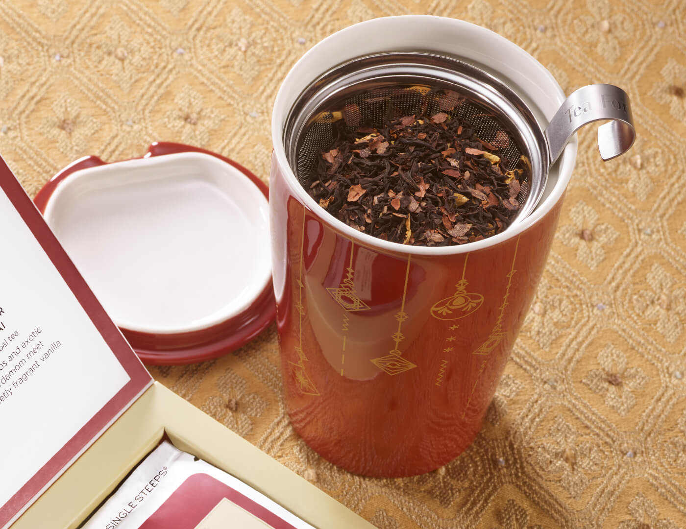 KATI Steeping Cup Warming Joy with lid removed, view from above, on a holiday styled table